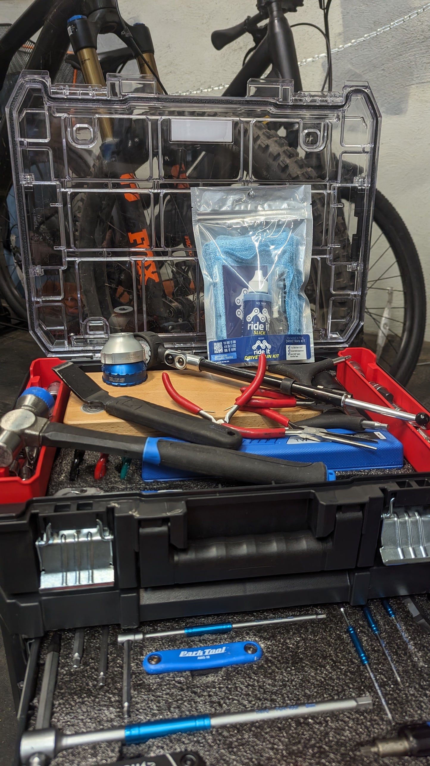 Ride It Drivetrain Kit by SCC Tech, featuring a complete bike maintenance solution. The packaging displays the Ride It brand logo and includes products like Ride It Slick, Ride It Clean, Ride It Smooth, and Ride It Flow. The kit contains 2 fl oz (59 ml) bottle of Ride It Slick drivetrain treatment, precision needle applicators, and a microfiber towel. The label highlights the kit’s focus on enhancing bike performance and protection, with bold text encouraging less time working on it and more time riding it