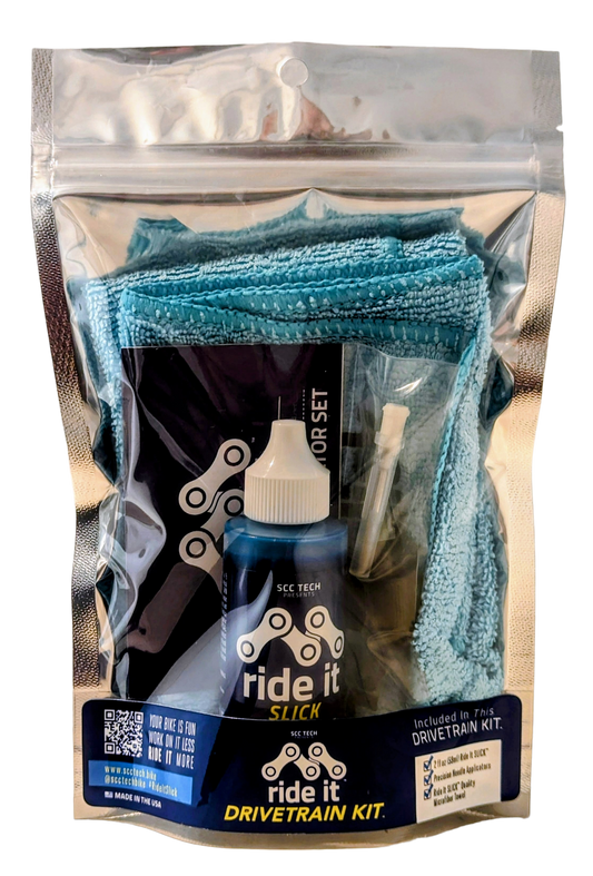 Ride It Drivetrain Kit by SCC Tech, featuring a complete bike maintenance solution. The packaging displays the Ride It brand logo and includes products like Ride It Slick, Ride It Clean, Ride It Smooth, and Ride It Flow. The kit contains 2 fl oz (59 ml) bottle of Ride It Slick drivetrain treatment, precision needle applicators, and a microfiber towel. The label highlights the kit’s focus on enhancing bike performance and protection, with bold text encouraging less time working on it and more time riding it